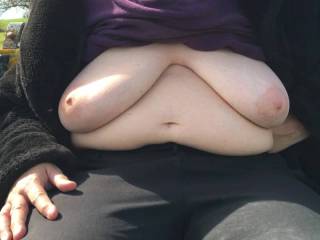 A lovely scene, and a farmhouse a few hundred metres away, so hoping nobody would be looking. She sits on a seat that someone kindly put in a field, and flops out her big tits, on a sunny afternoon.