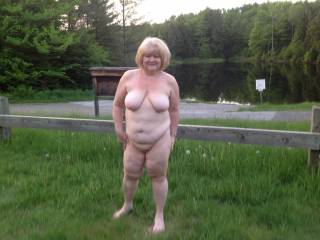 I am running around nude at boat ramp where some guys are fishing acroos the way on lake edge. Cars are coming and going in area. My husband hopes some guys catch me and gangbang my ass and pussy full of cum for being so bad in public. What do you think?