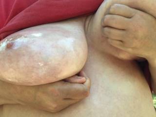 Lifting one tit up so the guest can put the finishing touches to the oiling