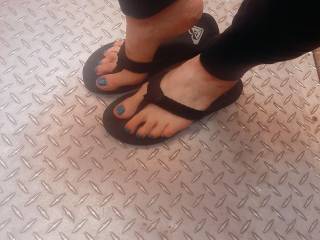 Showing off her new blue sexy long toes in black flip flops