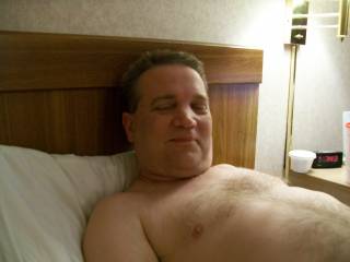 laying in hotel room, face and chest shot