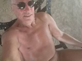 Naked on a swing outside.