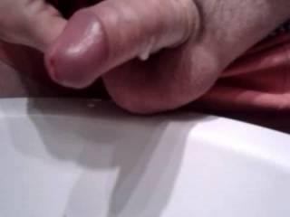 Stroking my thick uncut cock hard into a funnel, foreskin sliding back, big throbbing head dumping a heavy load straight into it.