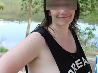 wife posing  with her tits getting ready to come out at the campground