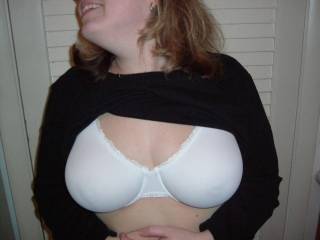 my wife, flashing her bra covered big natural tits.