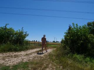 On this hot summer day, I had to present myself naked in public with a stiff cock. I was standing just a few meters from a country road and could have been discovered at any time.