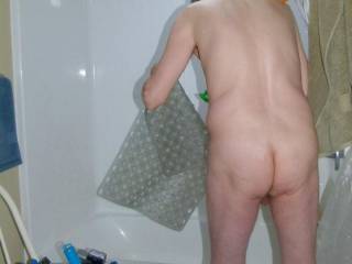 My body and butt, barely see my balls as I stand at my tub and holding one of my bath/shower mats... May 3RD 2025. FZ100 camera was used.