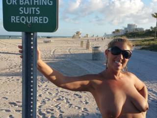 Here she is posing on both sides of the sign at Haulover beach in Miami.