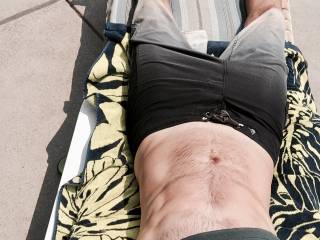 At the pool, wishing I could take my suit off.