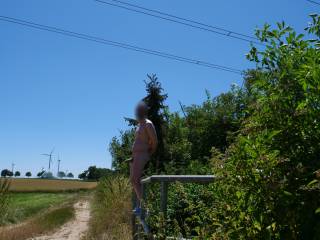 On this hot summer day, I had to present myself naked in public with a stiff cock. I was standing just a few meters from a country road and could have been discovered at any time.