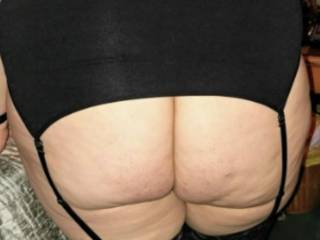 Showing off her ass In her garter belt do you like it