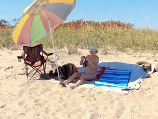 Nude women seat on beach towel