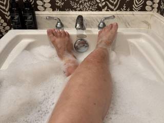 Relaxing in the tub with bubbles.