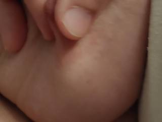 Closeup of me doing a little nip pinch while she\'s sucking my dick.
