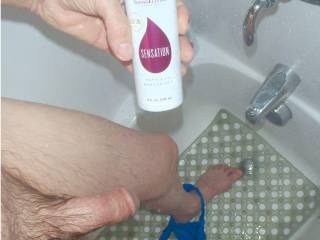 My dick and left leg as I look down plus holding my bottle of \'sensation\' shampoo...late April 2025. Another TG 810 camera was used.