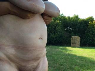 While showing her cunt and oiled big tits, she sees a haystack in the distance ...