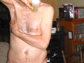 A partial body frontal as I pour a mix of essential oils & massage lotion near my left shoulder plus above my chest in late April of 2025. A S70 camera was used.