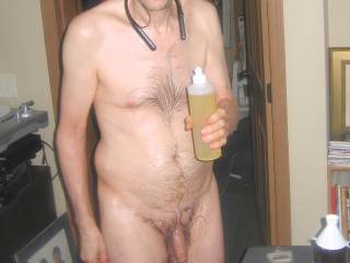 A partial body frontal as I stand holding the bottle containing a new mix of essential oil/massage lotion... Late April 2025. One of the S70 camera`s was used.