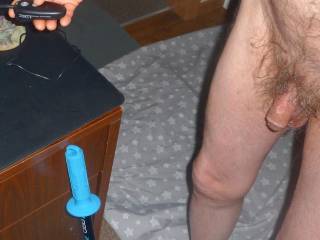 A partial lower body view as I stand near the corner of my desk and holding a wireless remote receiver for a FZ Panasonic camera... in late April of 2025. A Z4 camera was used.