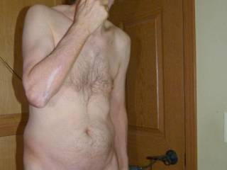 A partial body frontal in the bathroom as I stand shaving my face...  May 3RD 2025. FZ100 camera was used.