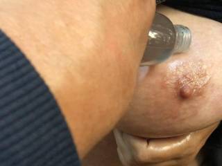 She lifts her big tits up to help a gentleman oil them