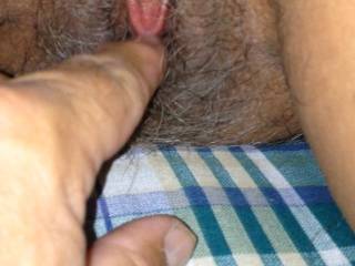 I flicked her clit. Her hairy pussy was dripping.