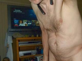 A partial body frontal as I stand in front of the TV with my Netflix list. A FZ150 camera was used.