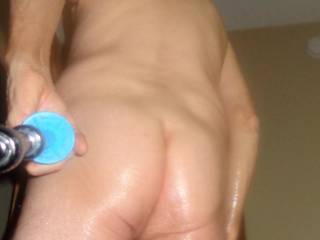 A selfie as I stand in my bed room that includes my butt and essential oil/massage lotion upon the back of my thighs. Early May 2025... Sony H90 camera was used.