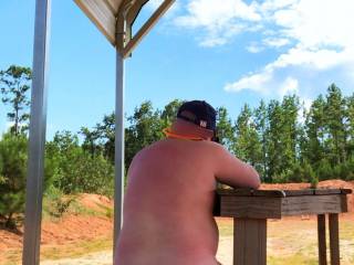 A day shooting at the range. I decided to shoot a little while naked. It\'s more fun that way. Yes, this is a public range. The back is open to a road separating the shooting points. I was totally visible from that road.
