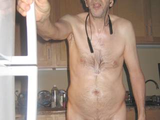 A partial body standing frontal as hold/grasp the freezer door handle...September 2025. 1of 3 Canon S70 camera was used.
