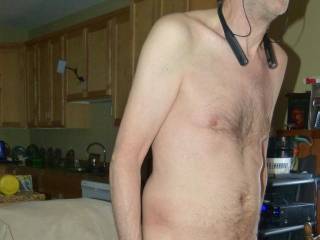 A partial body frontal as I stand with my dick still a redwood color due to the smearing/rubbing of tong balm upon it...  Late April 2025... FZ100 camera was used.