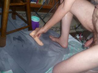 Another view of me with one knee on the floor with a hard dick as I attempt to use the toy to recycle the lube puddle that`s near the bar stool... early May 2025... Z50 camera was used.