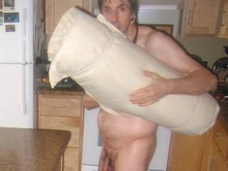 A partial body frontal as I stand in my kitchen and holding my over size old yoga mat that I had under the pet blanket... they were both on the kitchen island. Early May 2025. S70 camera was used.