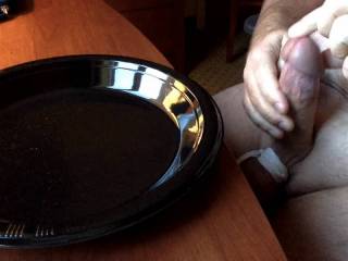 Masturbating and cumming on a black plate
