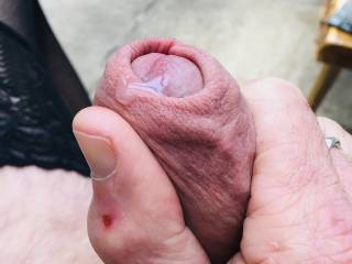 Squeezing the precum out.