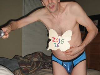 A selfie frontal partial body view of me wearing my blue undie at night in my bedroom with the blinds closed. A Sony W290 camera was used on a monopod.