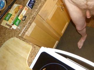 A partial lower body scene from my dick down to my right foot as I stand near my stove with a cooking timer running in late April of 2024. Camera used, FZ 150.