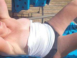 She didn\'t realize her top came down while getting some sun