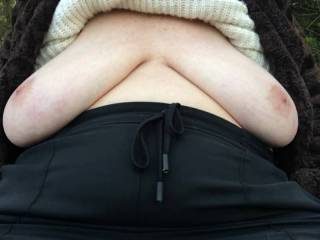 Sitting back on a wooden bench just outside woodland, my friend lifts her top and her big tits flop out and rest nicely ;)