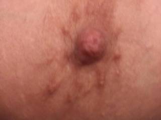 A close up of my friends wife's nipple. He loves to watch me suck on them