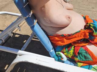 Sexy Debbie laying in sun at nudist resort