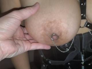 Another shot of the nipple ring, without the actual piercing needle portion. I don't want hard metal in my mouth when I suck those heavenly tits.
