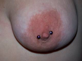 Close-up of Wifey's left tit with her new purple barbell, the piercing really is not that crooked, she was holding her top over her head!  LOL