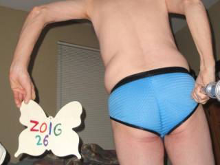 A selfie of me standing near my bed wearing my blue undie- a butt/body side with the blinds closed at night. A Sony W290 camera was used with a monopod.