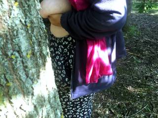Resting against a tree, then she looked round it and saw the guest was nearly here. She stepped back, turned towards him, lifted her shirt, smiled and held her tits up, saying hello again ...