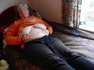 Relaxing on his bed, waiting for the rain to stop. Meanwhile, her tits are out ;)