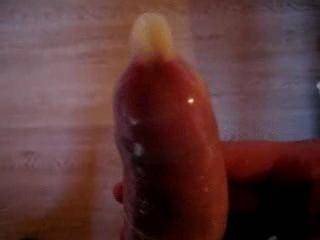 standing cumshot in condom with close-up