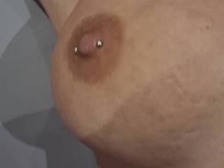 Examining her big pierced fake tits