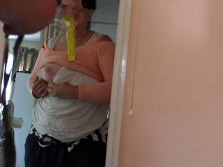 Dedication. Rather than put the Popsicle down she holds it in her mouth, so she can do as the photographer requested. She stands in the doorway and shows him one tit teasingly, just popping it out over the neckline of her white top and holding it there