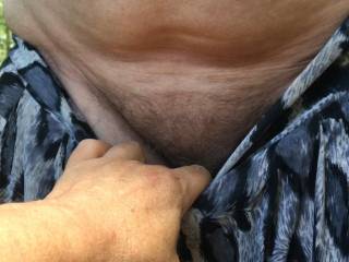 This guy helps with her trousers, while his friend stands behind - she lifts her arms to help him take her top off.